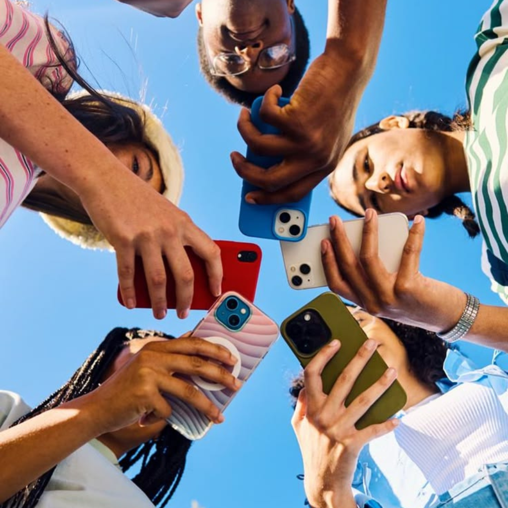 Diverse group of people using smartphones to explore Instagram social media trends